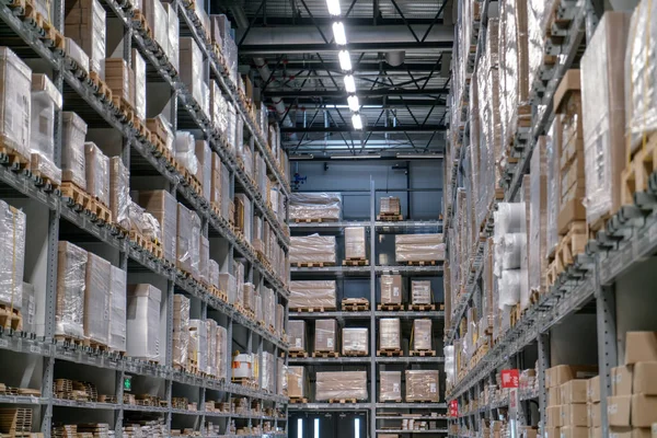 The warehouse full of goods, boxes and shelves in order