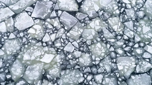 floating ice floes on water, aerial view