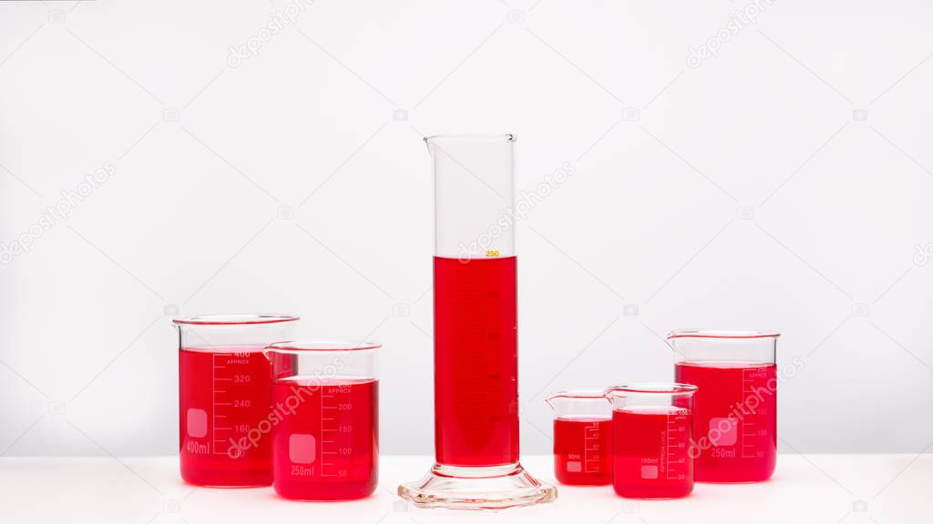 Group of laboratory glassware brightly colored liquid. Science concept