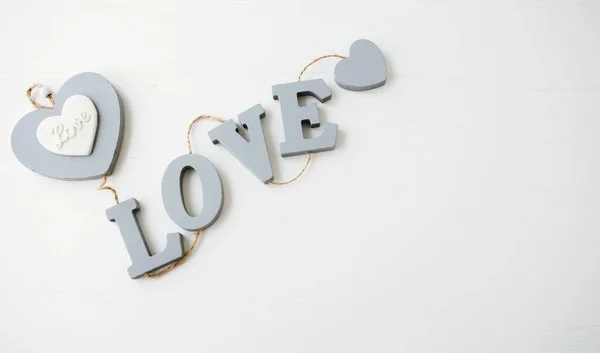 LOVE word made of wooden shapes on white background.
