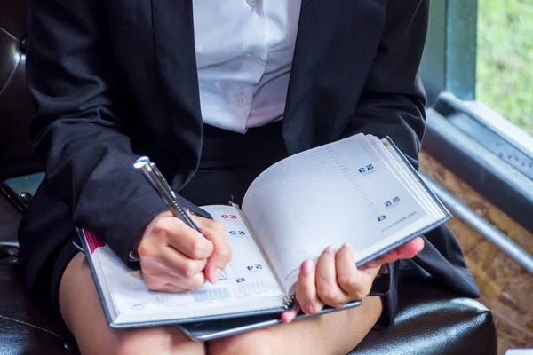 Female business are writing and reading some papers on the desk at company.