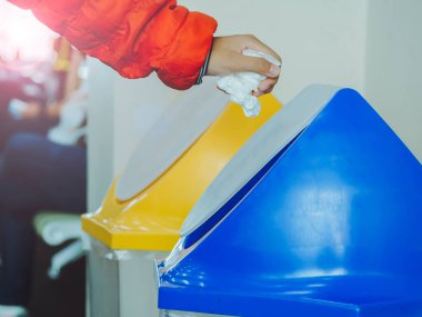 El, havalimanındaki çöpte kağıt mendil tutuyor. İmha ediliyor