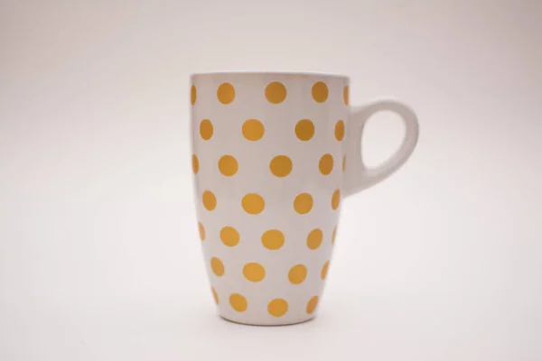 One cup for coffee on a white background. Coffee cup with a pattern in the form of circles on a white background. Layout, copy space.