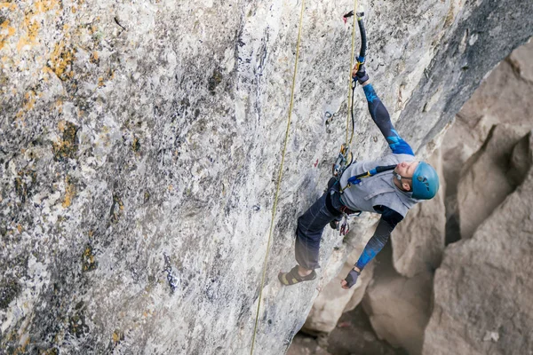Climbing man on a rock. — Stock Image Climbing man on a rock. Stock Picture
