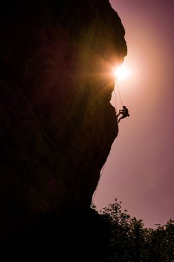 Man climbs rock. clipart