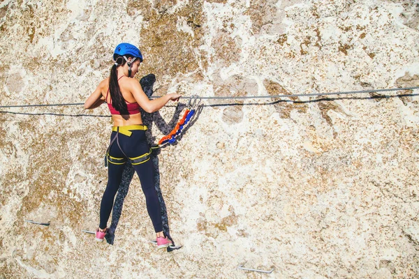 Woman climbing mountain.