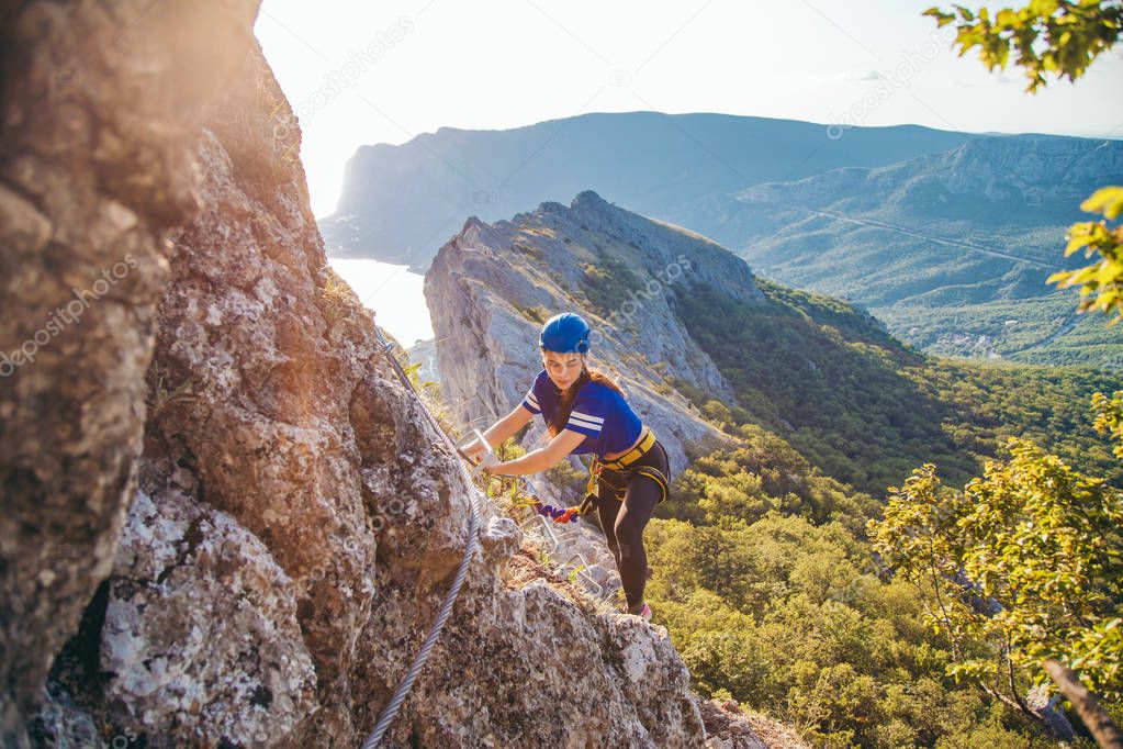 Woman climbing mountain. 