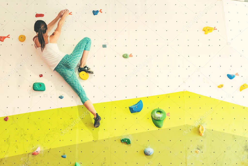 Woman in boulder gym.