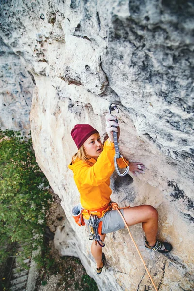 Girl climbing a rock.