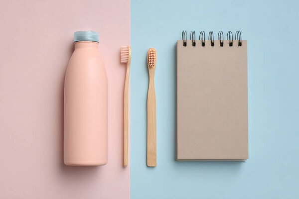 Eco-friendly bathroom accessories showcasing zero-waste lifestyle with bamboo toothbrush, reusable bottle on soft pastel backdrop