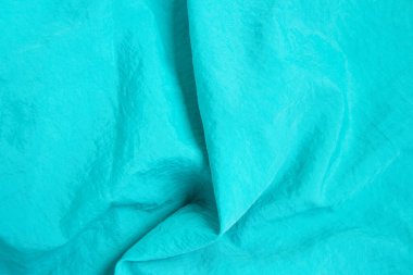 Turkuaz ipek doku arka planı. Mavi saten arka plan, kapat. Seçici odak