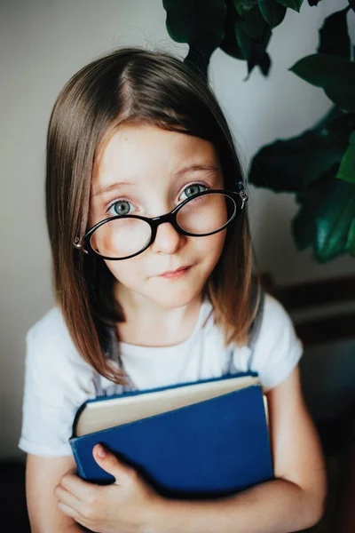 Uma menina segurando um livro — Fotografia de Stock