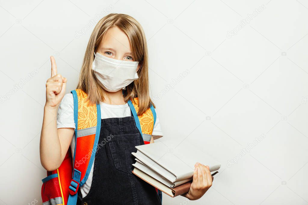 A child in a medical mask prepares for school