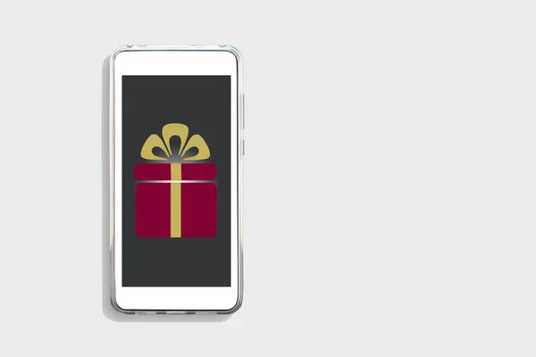 Gift box on smart phone screen on white background, online happiness concept and smart life idea