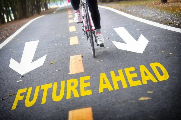 Future ahead word with white arrow sign marking on road surface for giving directions. Business success concept and challenge idea
