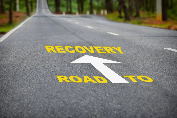 Road to recovery words on road. Economic recovery concept and business challenge idea