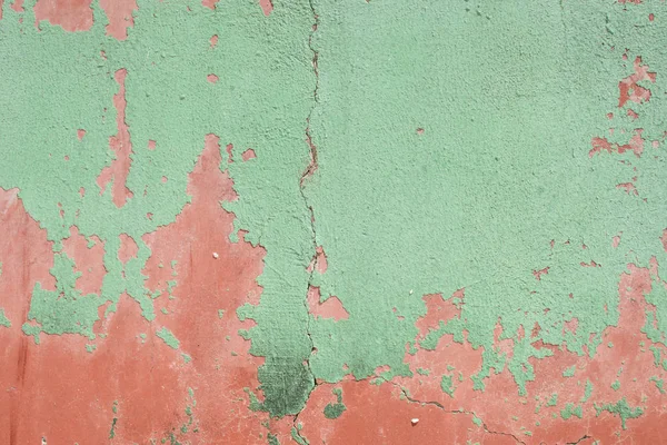 Green plaster on the wall of red plaster. — Stock Photo, Image