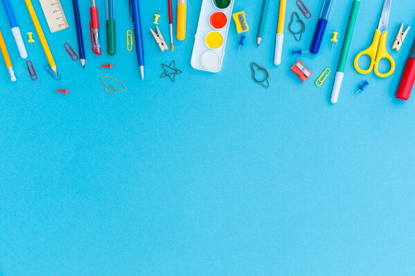 Office and school supplies on blue background. Copy space. Back to school concept.
