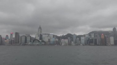 Hong Kong, Çin, 12 Nisan 2019 : Yağmur gününde Victoria Harbor ve Hong Kong Adası Skyline yavaş hareket. Hong Kong en yoğun nüfuslu şehir biridir.