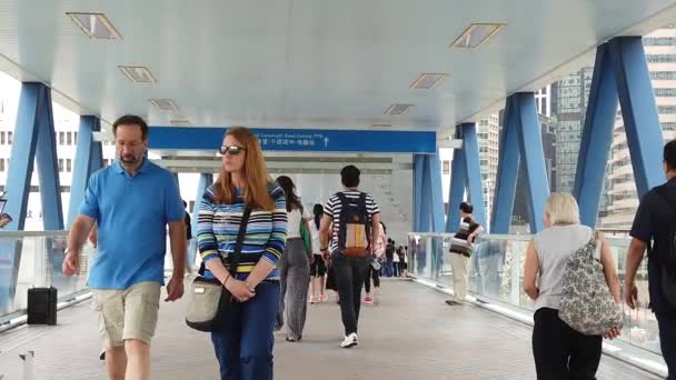 Slow motion of people walking suspended footbridge crossroad traffic street — Stock Video