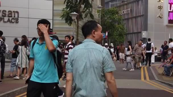 Movimento lento de pedestres caminhando ao longo da estrada movimentada — Vídeo de Stock