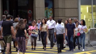 Hong Kong, Çin, 17 Nisan 2019: Hong Kong des Voeux Road Central District meşgul sokakları ve Zebra üzerinde yürüyen yayalar yavaş hareket.