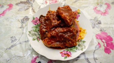 Ev yapımı Ayam Masak Merah 'a yakından bakın. Geleneksel Malezya yemeği tabakta servis edilir. Tavuk kırmızı biber, domates ve sambal sosuyla pişirilir..