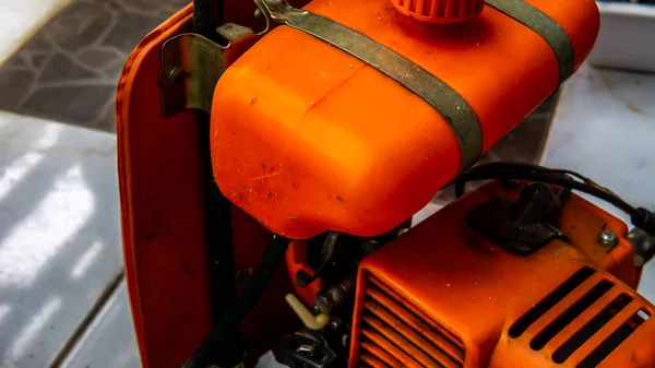 关闭地板上的橙色刷子切割机 割草机割草机机身细部 — 图库照片