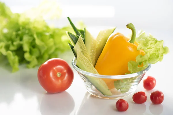 Набор свежих овощей на белой тарелке, для приготовления вегетарианского салата. Фон белый. — стоковое фото
