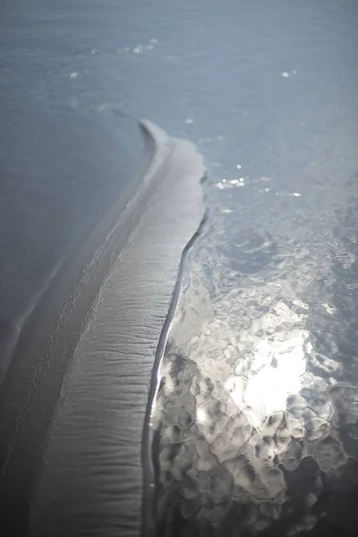 Island of sand in the water — стоковое фото