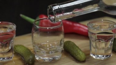 Votka fondip bardakları ahşap bir tahta üzerine yerleştirilmiş içine dökün