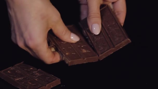 Woman Breaks Black Chocolate Bar Nuts Close Slow Motion — Stock Video