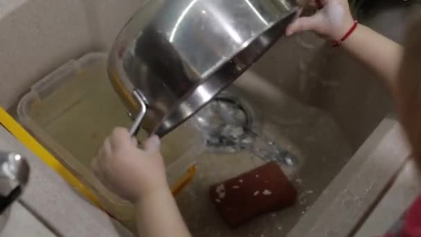 Dziecko, zmywanie naczyń w kuchni. Zbliżenie na ręce dziewczyny — Wideo stockowe