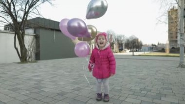 Mutlu çocuk Street helyum balonlar ile atlama