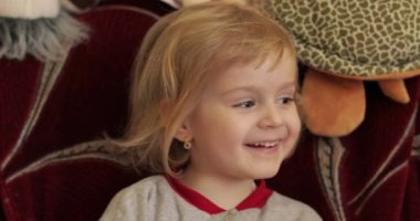 Küçük bir sarışın sevimli kız yüzünü kapat. Gülümseyen kız. İçeride. Portre vurdu