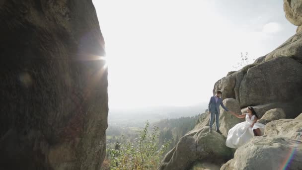 산의 높은 경사에 신부 신랑. 웨딩 커플. 색 태양 열 — 비디오