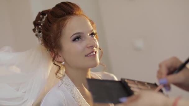 Artista de maquillaje de boda haciendo un maquillaje para la novia en el velo. Hermosa modelo sexy — Vídeos de Stock