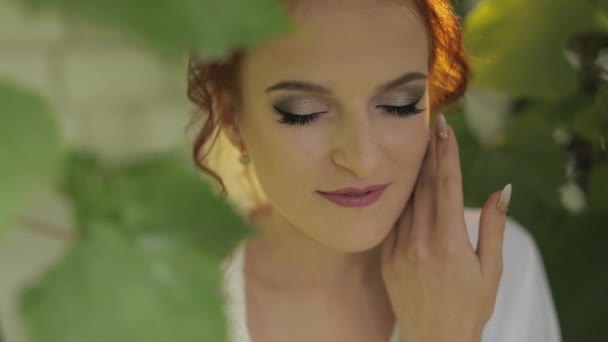 Beautiful and lovely bride in night gown and veil in the garden. Wedding morning — Stock Video