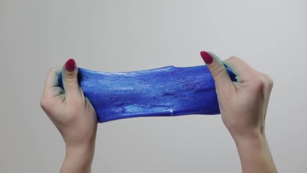 Woman hands playing with oddly satisfying blue slime gooey substance. Antistress — 비디오