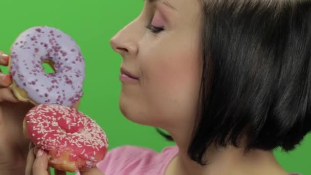 Gelukkig mooi jong meisje poseren en plezier met donuts. Chroma Key — Stockvideo