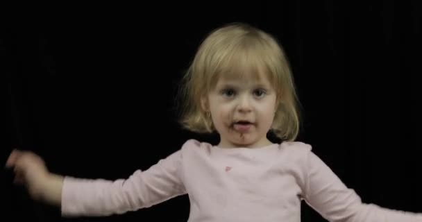 Bambino con la faccia sporca da cioccolato fuso e panna montata sorridente — Video Stock