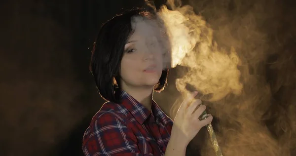 Beautiful, young woman smoking hookah. Attractive girl smoking flavored tobacco — Stock Photo, Image