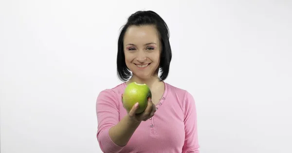 緑のリンゴと若い美しい視聴者に一口を提供しています。健康的な栄養 — ストック写真