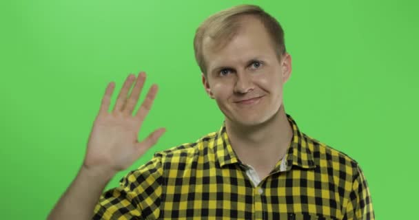 Handsome caucasian man waves and saluting on green screen chroma key — Stock Video