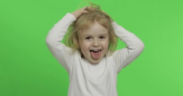 Happy little blonde girl in white t-shirt. Cute blonde child. Making faces — Stock Video