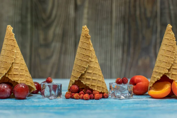 Berry and fruit ice cream. Apricot, strawberry, grape in a waffle cone — Stock Photo, Image