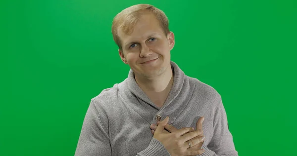 Handsome young man in gray sweater doing love gesture. Chroma key — Stock Photo, Image