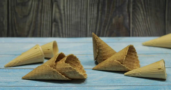 Ice cream cones, isolated on blue wooden surface. Waffles for ice cream — Stock Photo, Image