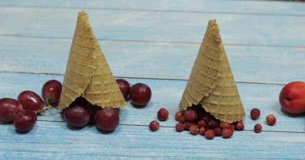 Berry and fruit ice cream. Apricot, strawberry, cherry in a waffle cone — Stock Video