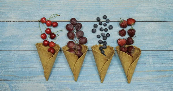 Berry and fruit ice cream. Blueberry, strawberry, cherry, grape in a waffle